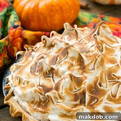 The most delicious pumpkin pie topped with a mountain of toasted brown sugar meringue.