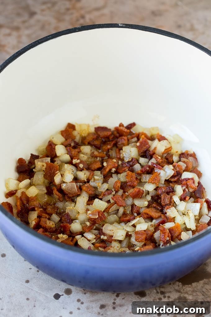 These Southern style mustard greens are cooked with smoky bacon and seasonings until tender and flavorful. Cooked bacon and onions in a pot.