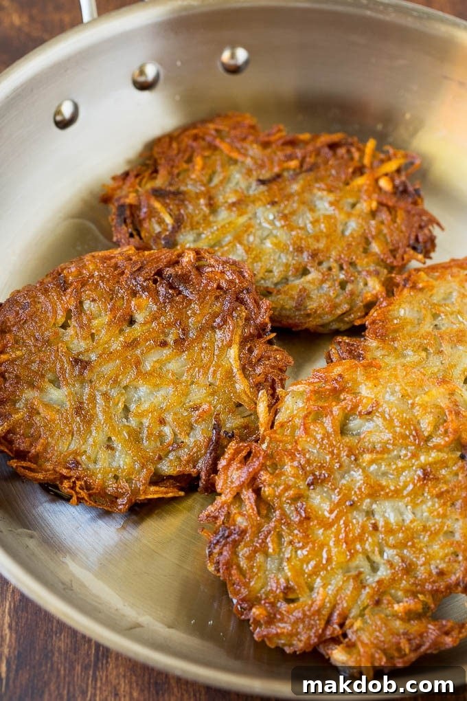 Cooked potato patties in a pan. Cooked potato patties in a pan.