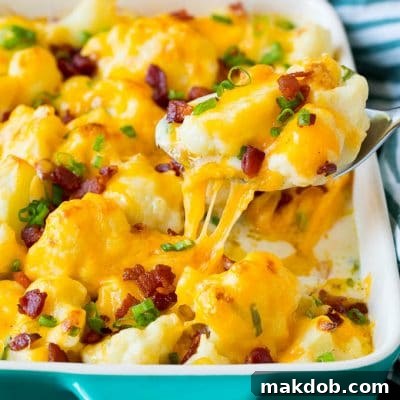 A spoon serving up a portion of cauliflower casserole.