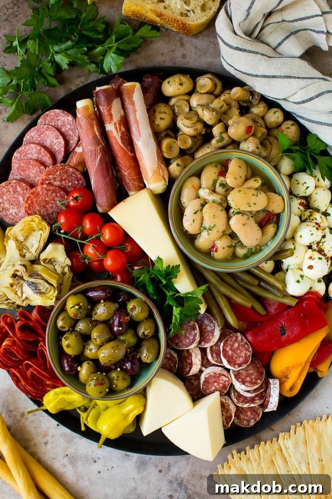 An antipasto platters with meats, cheeses, olives and vegetables.
