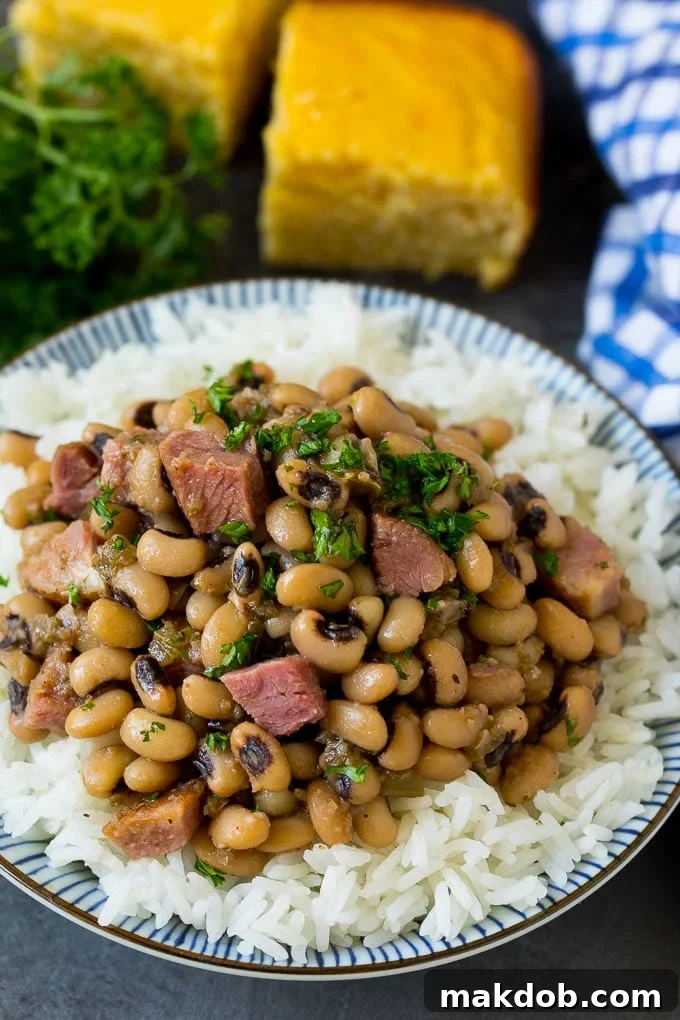 Hoppin' John with Rice and Parsley Garnish A bowl of Hoppin' John, generously served over steamed white rice and garnished with a sprig of fresh parsley, ready to be enjoyed.