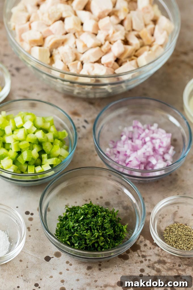 This turkey salad is a blend of diced turkey and colorful veggies, all tossed in a savory creamy dressing. Bowls of diced turkey, celery, onions and herbs.