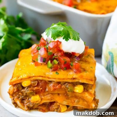 Ultimate Taco Lasagna 7 A slice of taco lasagna topped with salsa, sour cream and cilantro.
