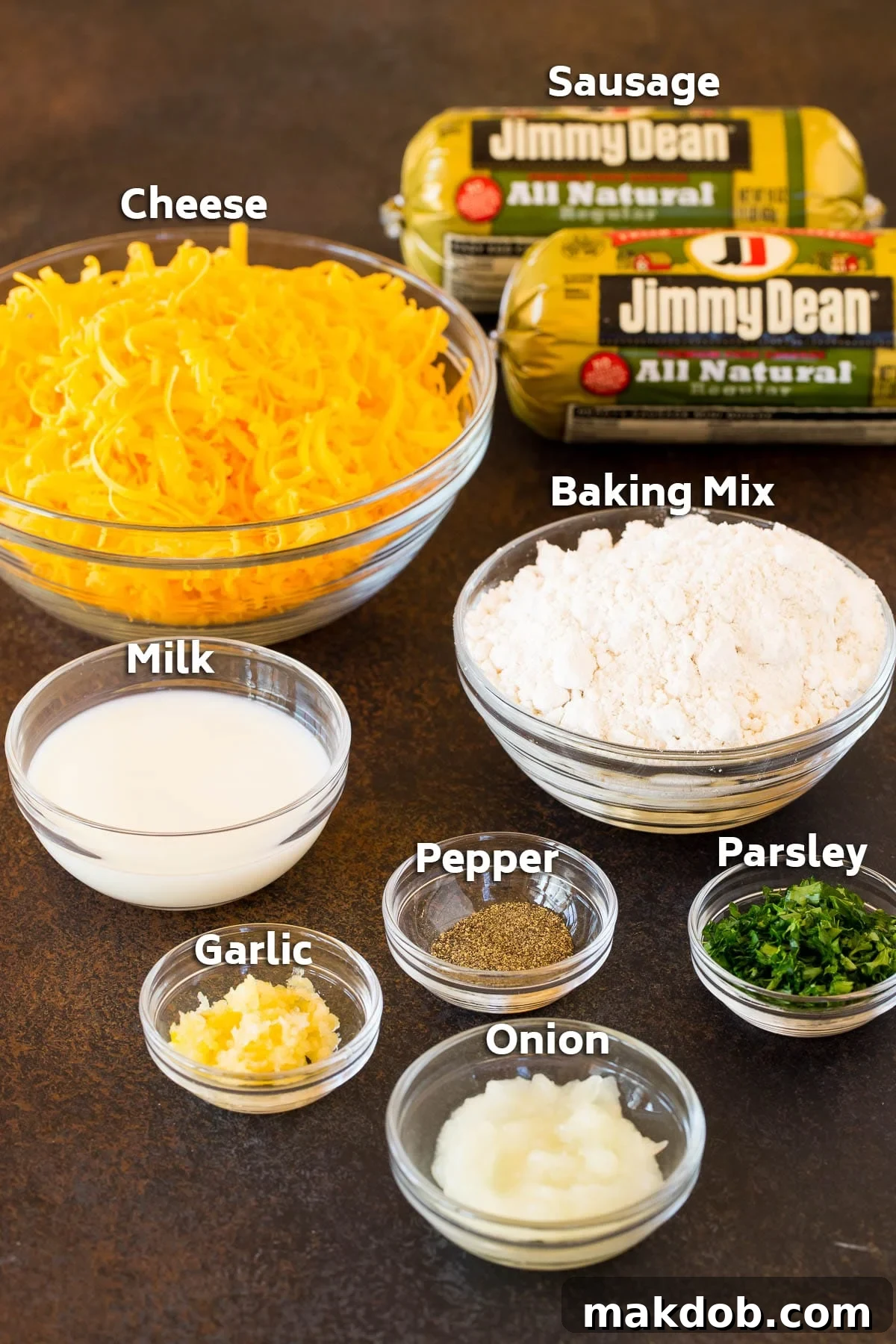 Easy Cheesy Sausage Balls 3 Bowls displaying key ingredients for sausage balls: ground sausage, shredded cheddar cheese, Bisquick baking mix, and minced aromatics.