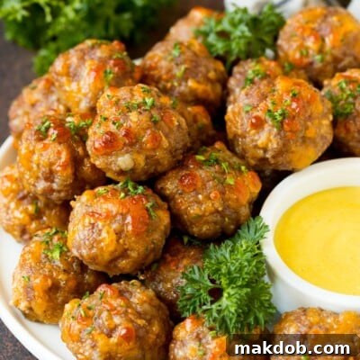 Easy Cheesy Sausage Balls 8 A serving plate of sausage balls served with dip.