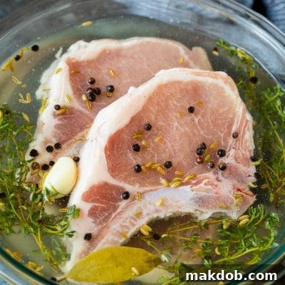 Mastering Pork Chop Brining 2 A bowl of pork chop brine with raw pork chops in it.