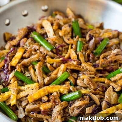 Mandarin Pork Wraps 7 A pan of moo shu pork topped with sliced green onions.