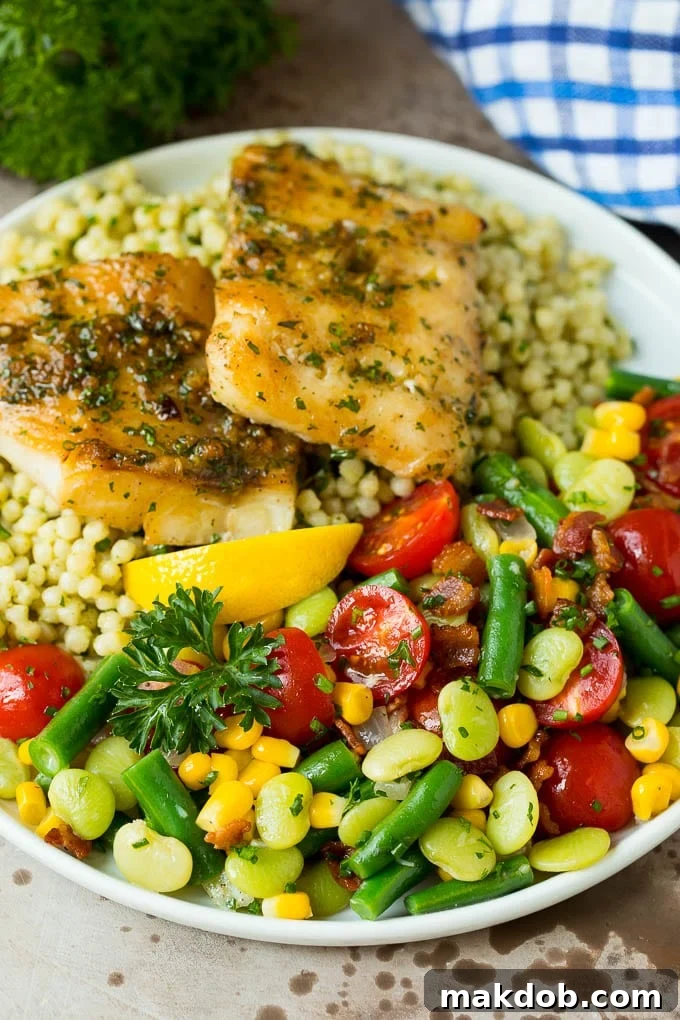 Succotash served on a plate with fish and couscous.