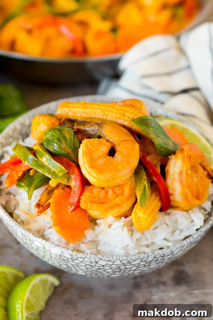 A bowl of shrimp curry served over rice.