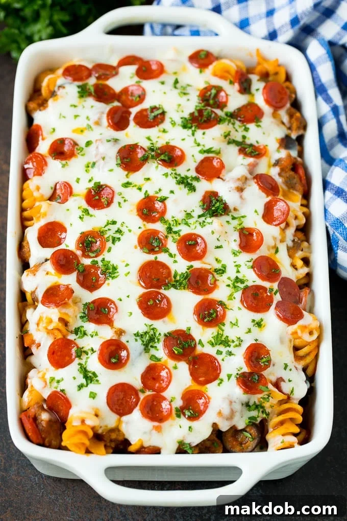 Pizza casserole with melted cheese and mini pepperoni on top, ready for a hearty family dinner. Close-up of a bubbling pizza casserole with perfectly melted mozzarella and crispy mini pepperoni on top, fresh from the oven and ready for serving. The golden cheese and savory toppings are highlighted.
