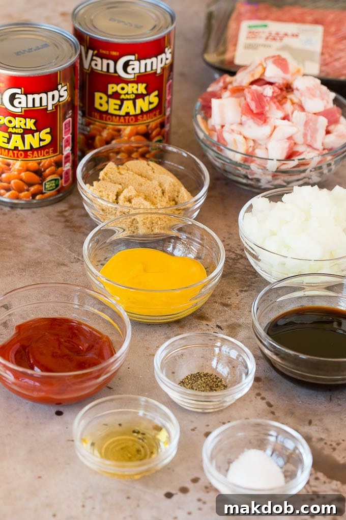 Ingredients for Cowboy Beans Individual ingredients laid out for a cowboy beans recipe, including strips of bacon, raw ground beef, and bowls of various seasonings.