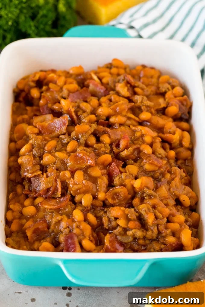 Serving Dish of Cowboy Beans with Bacon A rustic serving dish overflowing with cowboy beans, topped with generous pieces of crispy bacon.