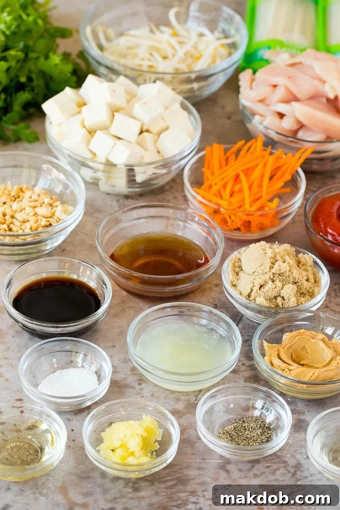 Various fresh ingredients meticulously prepped and arranged in bowls, ready for cooking a delicious Pad Thai.