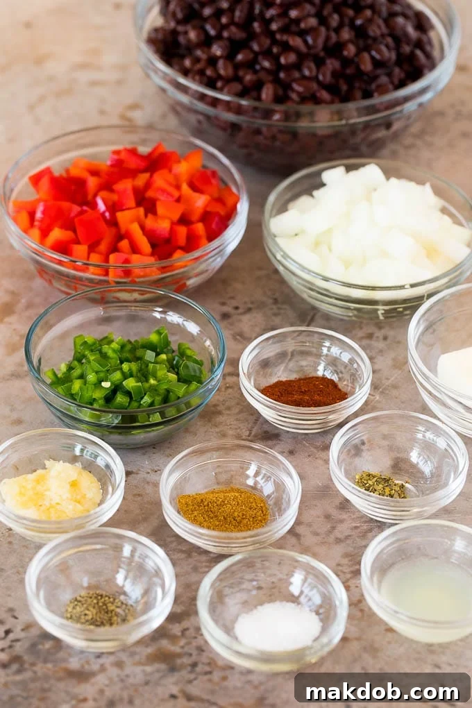 Glass bowls of ingredients including black beans, vegetables and spices.