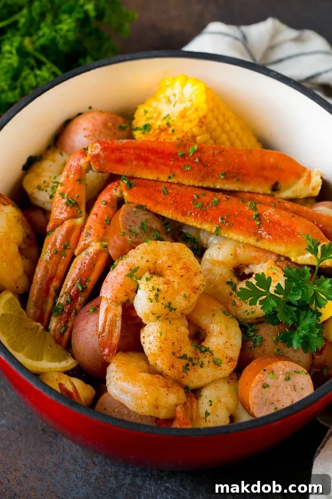 This Low Country Boil is a blend of shrimp, crab, sausage, corn and potatoes, all cooked together to create a hearty dinner. A pot of Low Country Boil with shrimp, crab and vegetables.