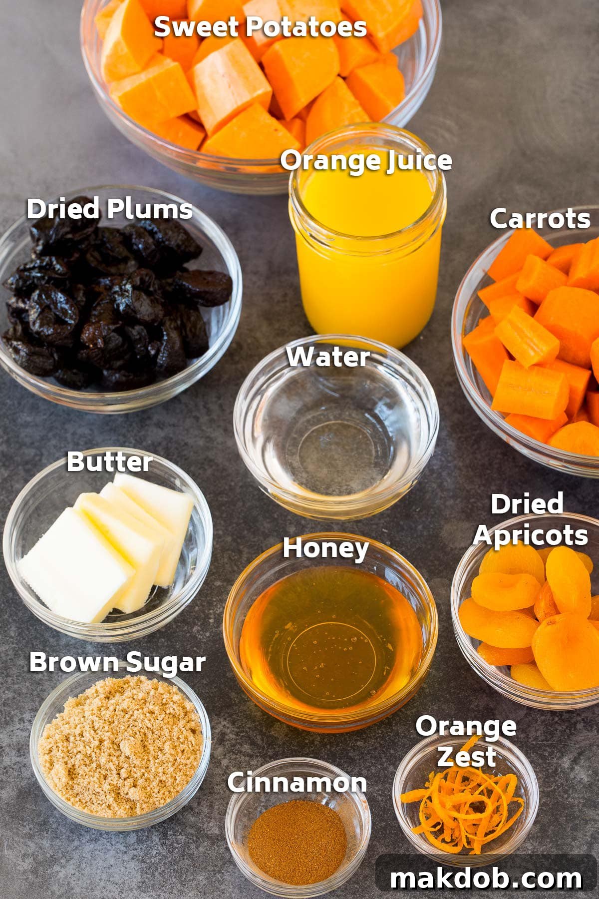 Sweet and Savory Holiday Tzimmes 3 Bowls showcasing the fresh and dried ingredients for Tzimmes, including vibrant sweet potatoes and carrots, dark dried plums, golden apricots, and aromatic spices.