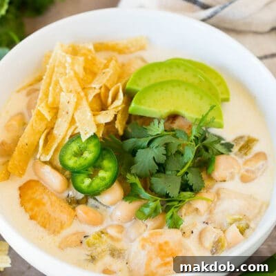 Creamy White Chicken Chili 2 White chicken chili topped with tortilla strips, cilantro and avocado.