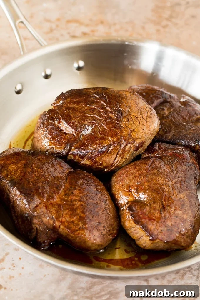 Seared steak in a pan.