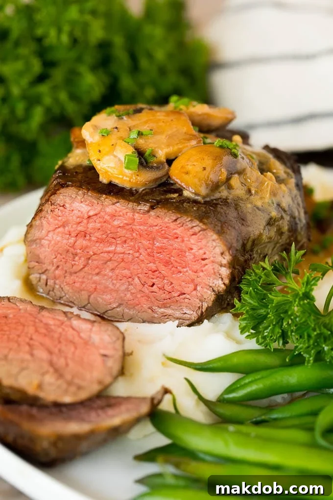 Sliced Steak Diane served with mashed potatoes and green beans.