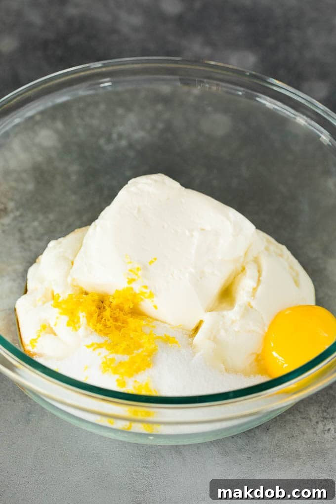 Bowl with ricotta cheese, cream cheese, sugar, egg yolk, and lemon zest.