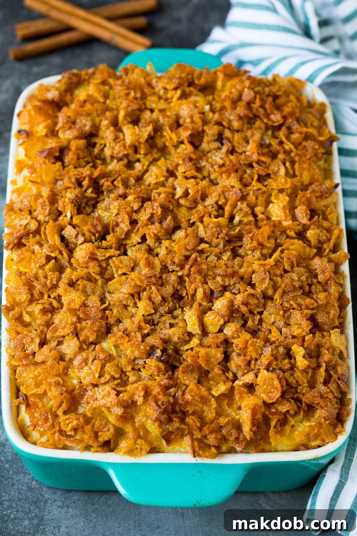 Golden Noodle Delight 6 A close-up view of a freshly baked noodle casserole, golden brown with a crispy cornflake topping, still in the baking dish.