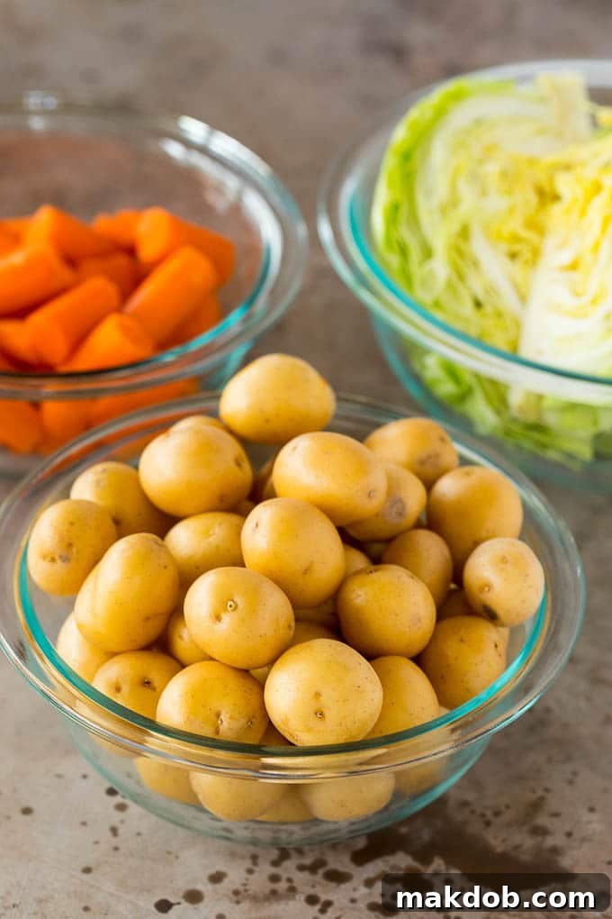 Cooked Potatoes, Cabbage, and Carrots Ready to Serve Bowls of perfectly cooked potatoes, cabbage, and carrots.