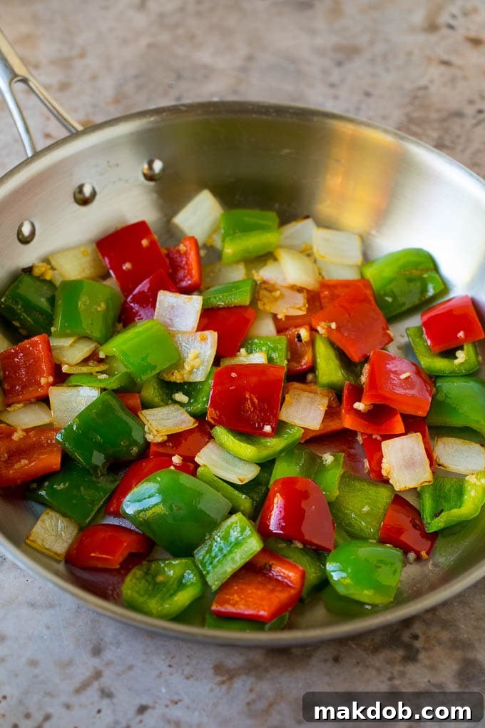 This kung pao beef is a combination of thinly sliced steak, bell peppers, onions and roasted peanuts, all in a savory and spicy sauce. Bell peppers, onions and garlic cooked in a skillet.