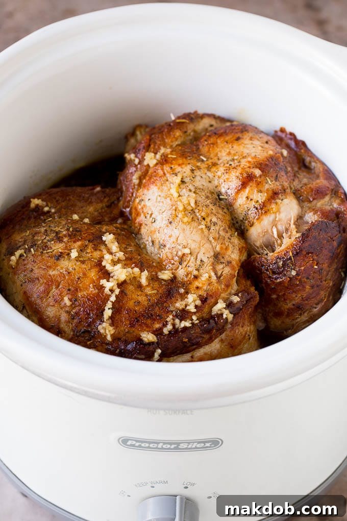 This crock pot pork roast is tender pork loin simmered in a slow cooker in a rich and flavorful gravy. Pork in a slow cooker coated in a savory sauce, ready for serving.