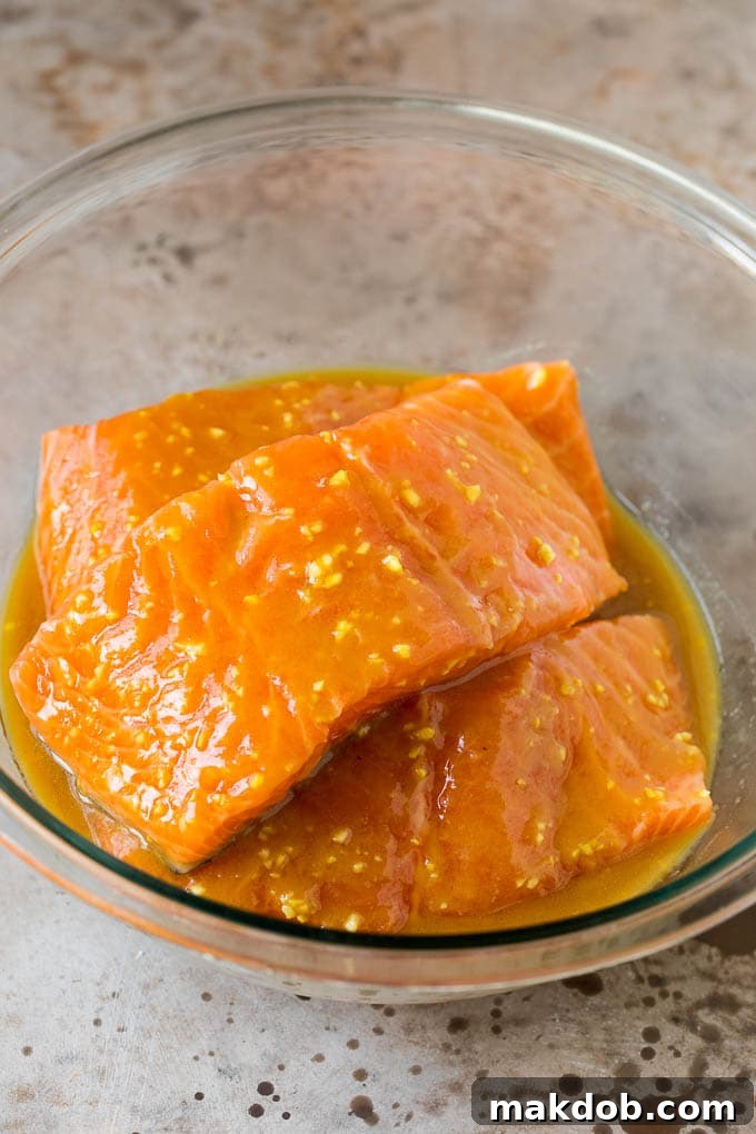 Salmon in a bowl of marinade.