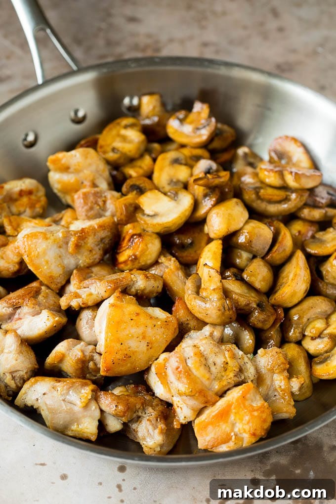 Cooked chicken and sauteed mushrooms together in a pan.