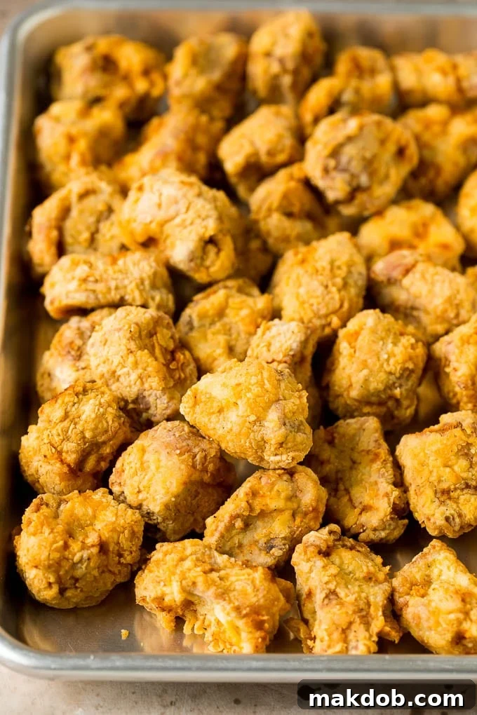 Crispy breaded and fried pork pieces, ready to be coated in sauce.