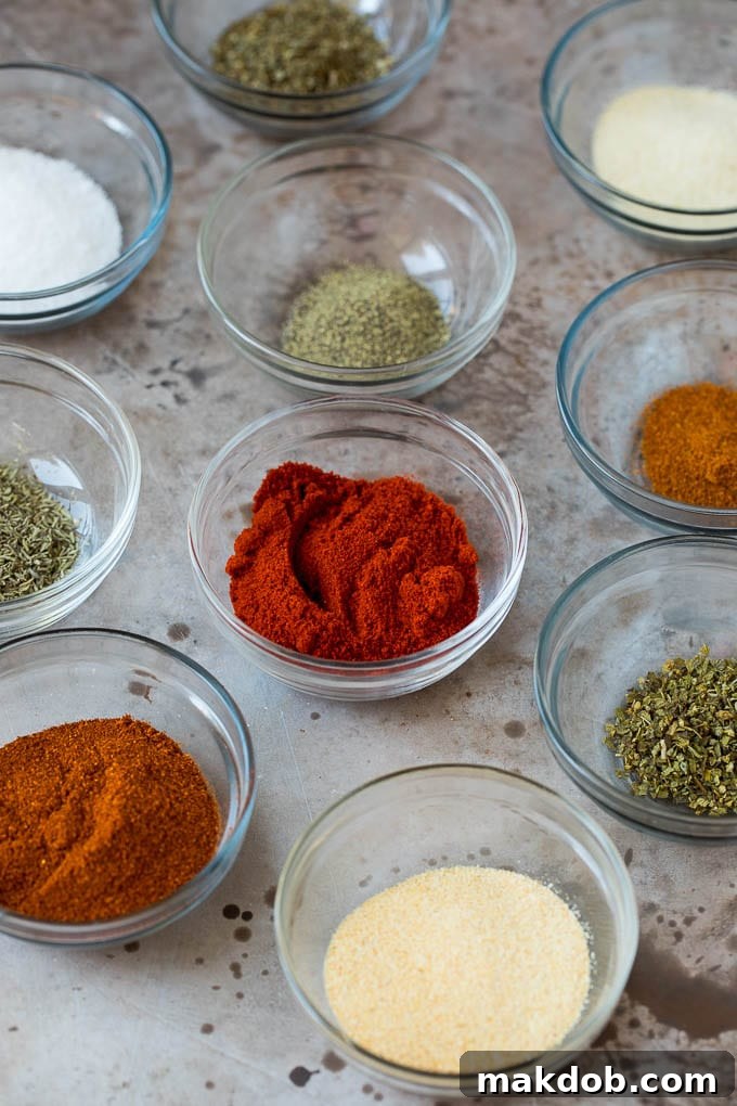 Ingredients for Blackened Seasoning Assorted small bowls of fresh herbs and dried spices used to make blackened seasoning.