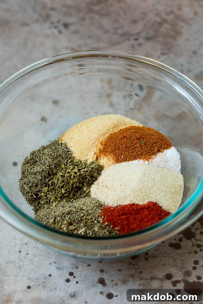 Mixing Homemade Blackened Seasoning A mixing bowl filled with an assortment of fragrant spices and dried herbs, ready to be blended into homemade blackened seasoning.