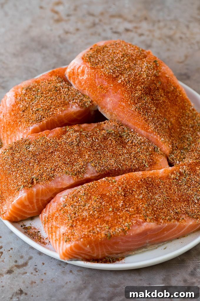 Salmon fillets coated with seasonings.
