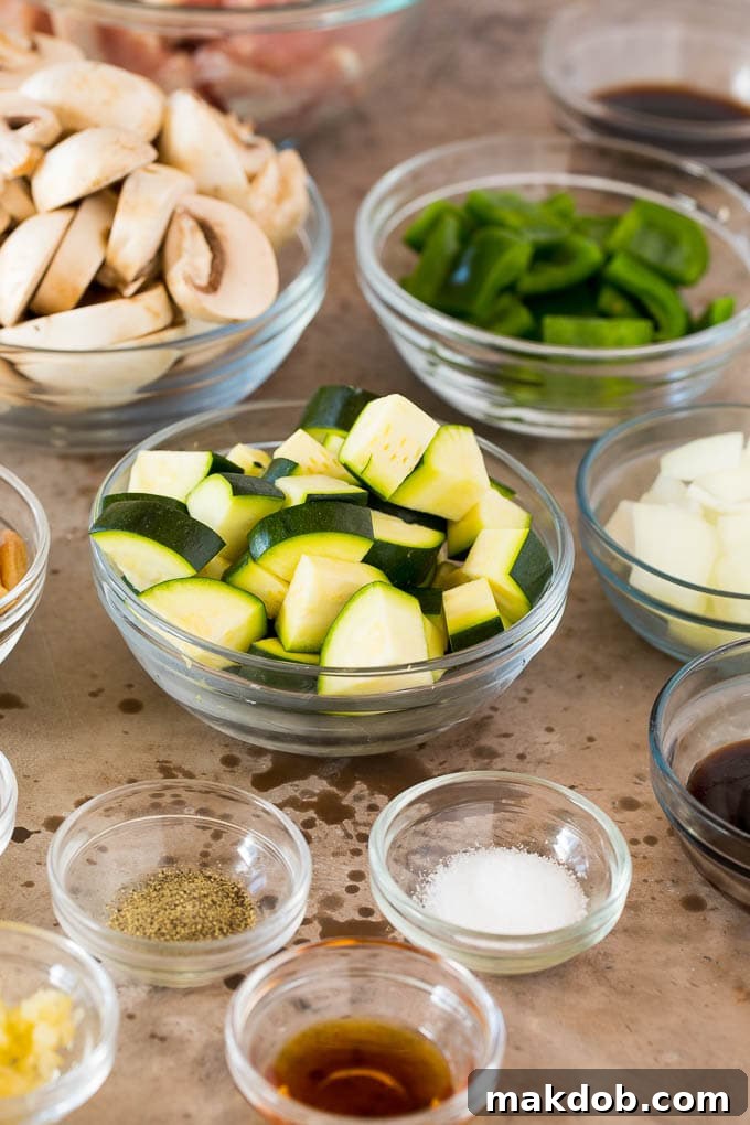 Bowls of diced vegetables and sauce ingredients.