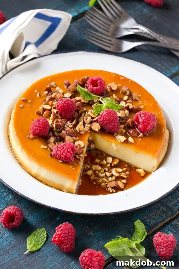 This rich and creamy flan is flavored with vanilla and almonds and is finished off with chopped honey roasted almonds and raspberries.