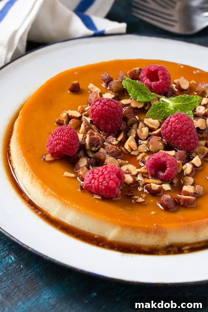 This rich and creamy flan is flavored with vanilla and almonds and is finished off with chopped honey roasted almonds and raspberries.