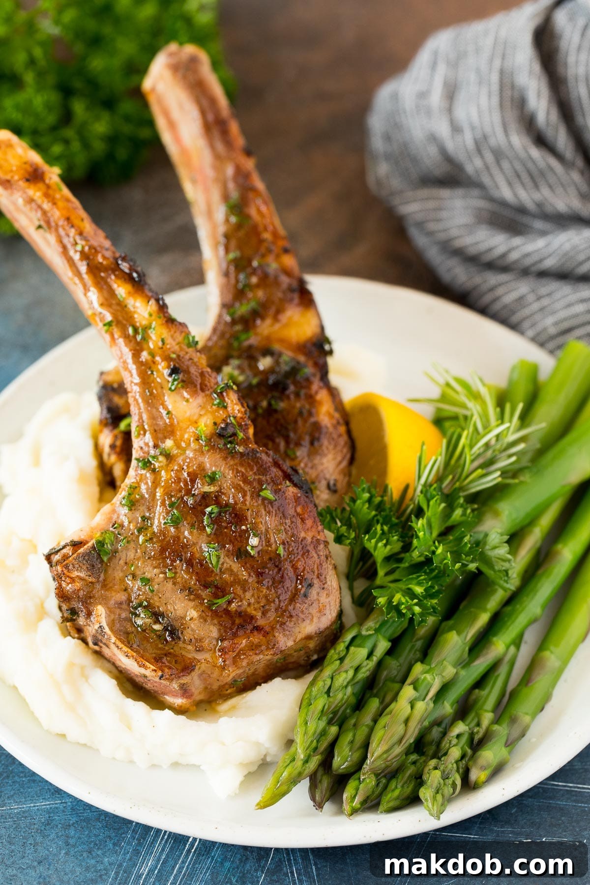 Flame-Kissed Lamb Chops 6 Grilled lamb chops served elegantly with mashed potatoes and fresh asparagus.