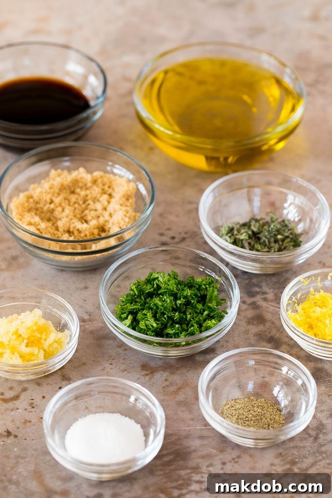 Fresh ingredients for a homemade chicken thigh marinade. Bowls of ingredients including garlic, herbs, olive oil and soy sauce, ready for making chicken thigh marinade.