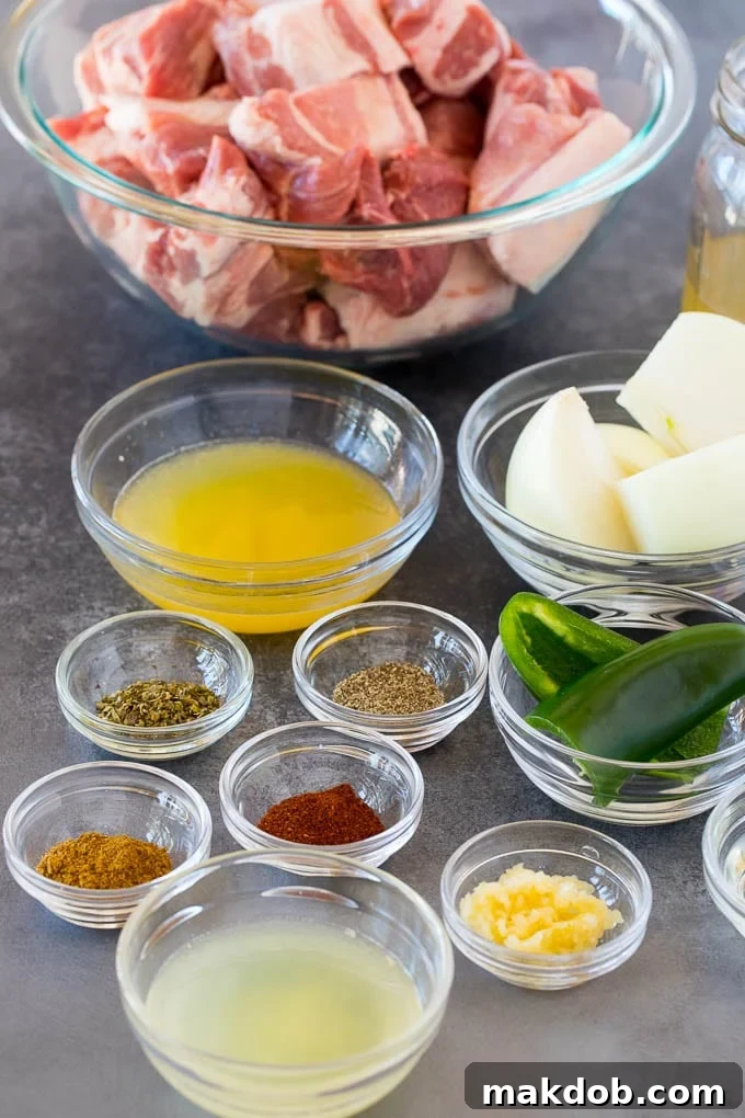 Bowls of fresh ingredients including pork, spices, onion, and jalapeno, ready for Instant Pot carnitas preparation.