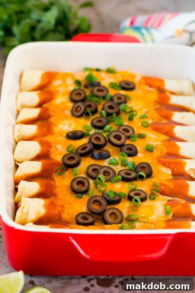 This recipe for cheese enchiladas is rolled flour tortillas filled with cheddar and Monterey Jack cheeses, then topped with red sauce and more cheese and baked to golden brown perfection. A dish of cheese enchiladas topped with olives and green onions.