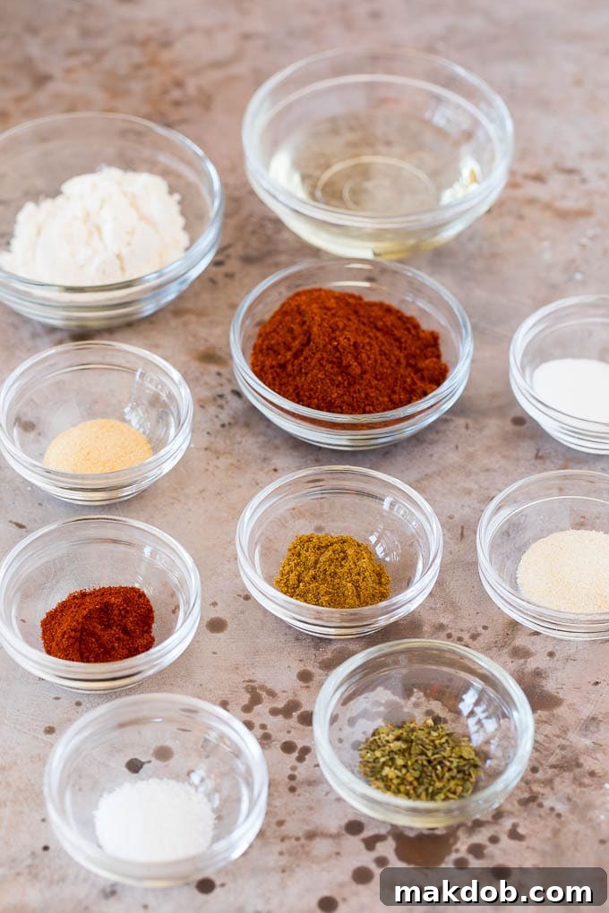 Enchilada Sauce Spices Small glass bowls containing various herbs and spices, ready for making enchilada sauce.