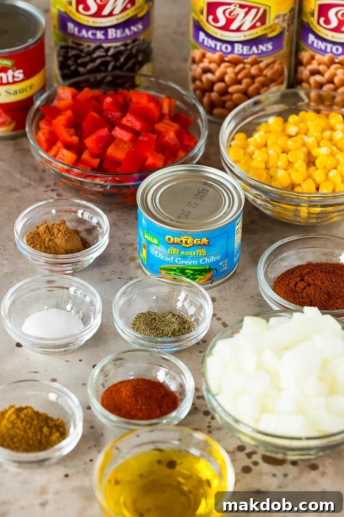 Fresh Ingredients for Homemade Vegetarian Chili A beautiful array of fresh chili ingredients laid out in glass bowls, including vibrant bell peppers, diced onions, and an assortment of aromatic spices.