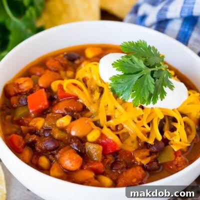 Plant-Powered Chili 2 A delicious bowl of vegetarian chili topped with shredded cheese and sour cream, ready to be savored.