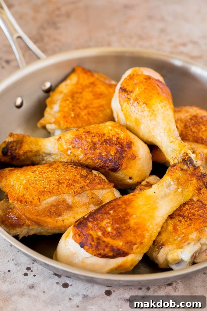This chicken adobo is a Filipino dish made with chicken pieces simmered in a sweet and savory sauce. An easy dinner option with minimal ingredients that always gets rave reviews! Browned chicken pieces in a skillet.