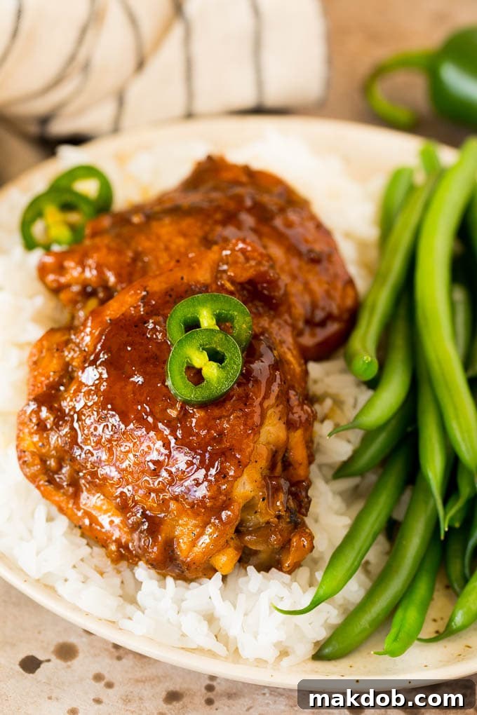 This chicken adobo is a Filipino dish made with chicken pieces simmered in a sweet and savory sauce. An easy dinner option with minimal ingredients that always gets rave reviews! Chicken adobo served with rice and green beans.