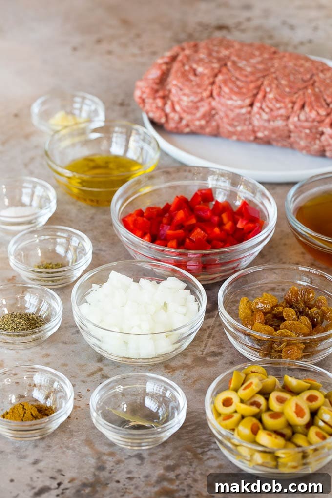 Bowls of ingredients including vegetables, spices, olives and raisins.
