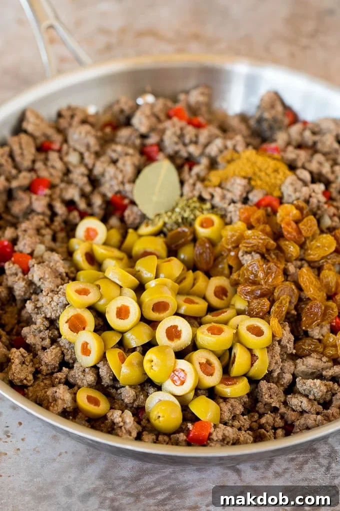 Cooked ground beef with olives, raisins and spices.