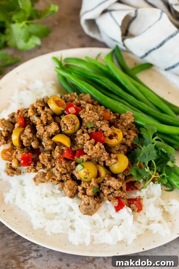Picadillo served over rice with a side of green beans.
